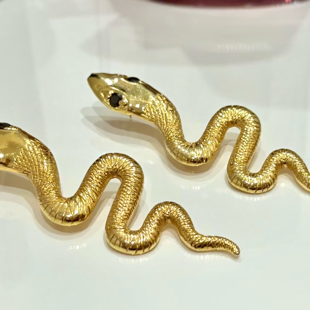 Stylized Gold and Black Snake Earrings with Shiny Finish